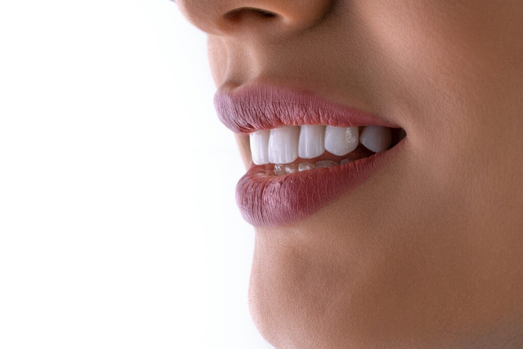 A dentist explaining crown lengthening to a patient at Lumino Dental in Langley, BC
