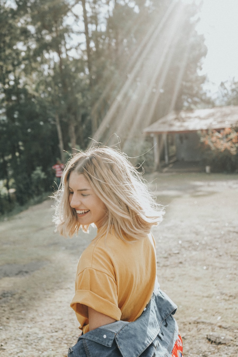 A happy patient smiling outdoors near Lumino Dental in Langley, BC