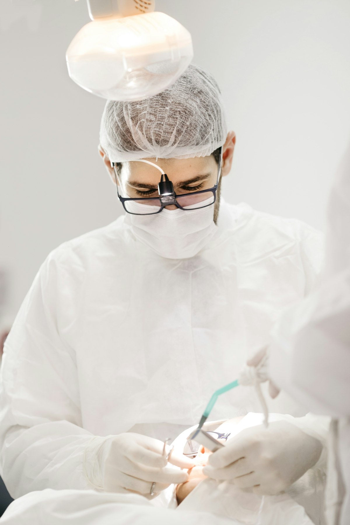 A dentist performing a careful procedure at Lumino Dental in Langley, BC